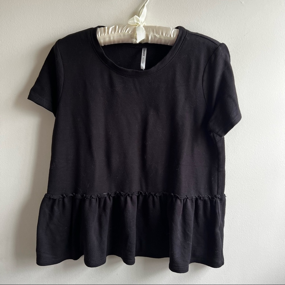 Black blouse with ruffle detail by Tresics